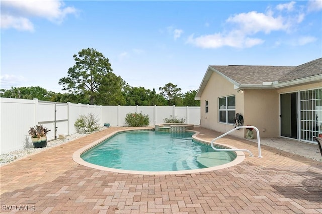 view of pool with a patio area, a fenced backyard, and a pool with connected hot tub