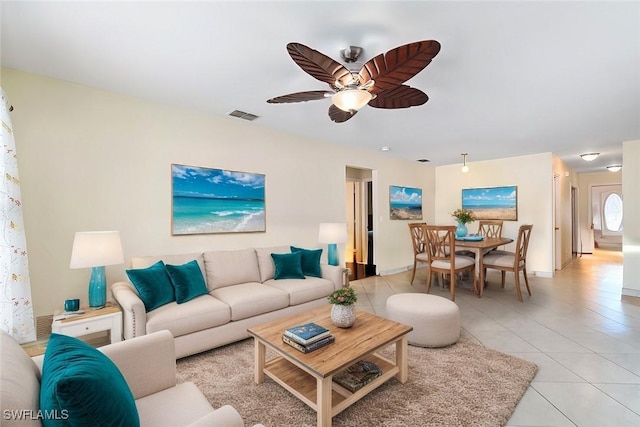 living room featuring visible vents, ceiling fan, and light tile patterned floors