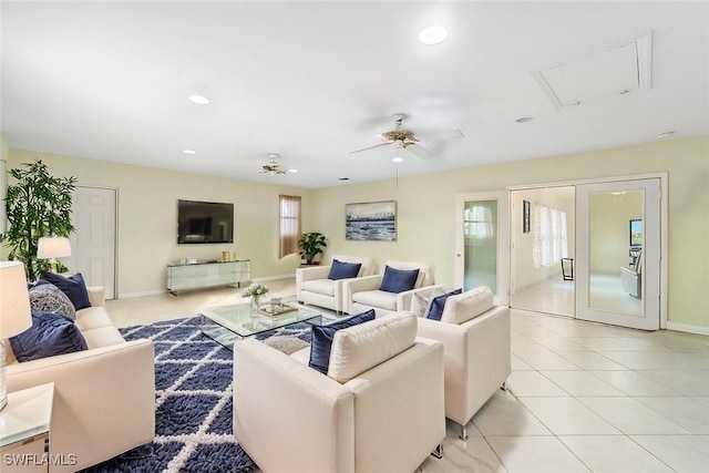 living area with light tile patterned floors, baseboards, a ceiling fan, and recessed lighting