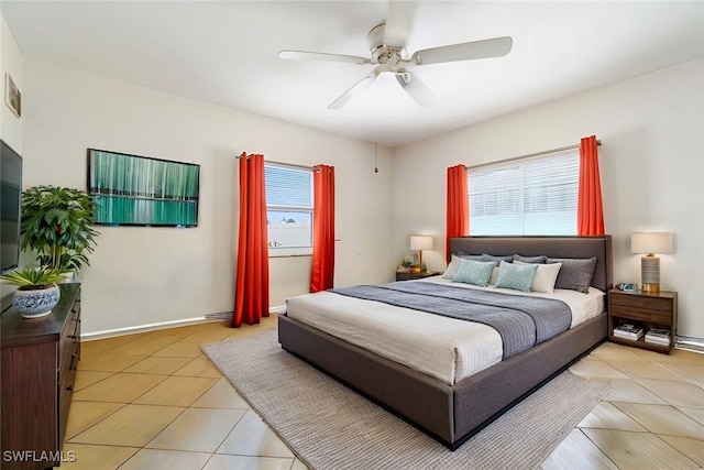 bedroom with light tile patterned floors, ceiling fan, visible vents, and baseboards