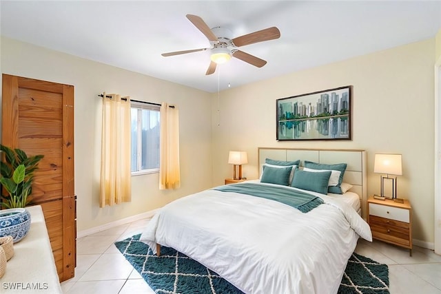 bedroom featuring light tile patterned floors, ceiling fan, and baseboards