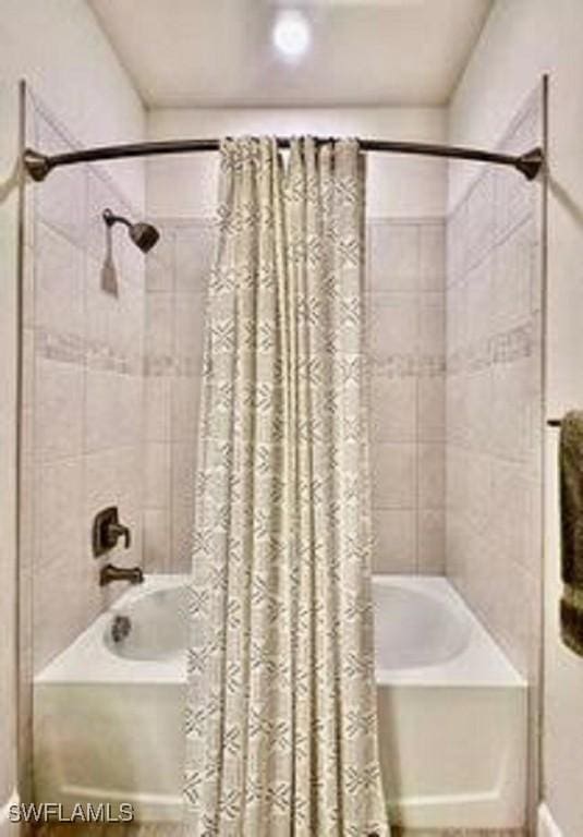 bathroom with shower / bathtub combination with curtain