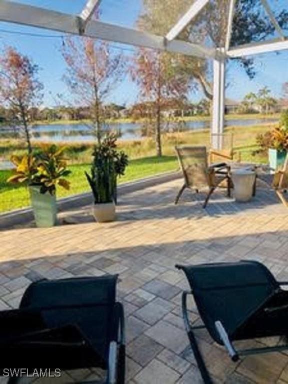 view of patio with a water view and a pergola