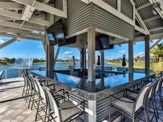 view of patio / terrace featuring a water view and a bar