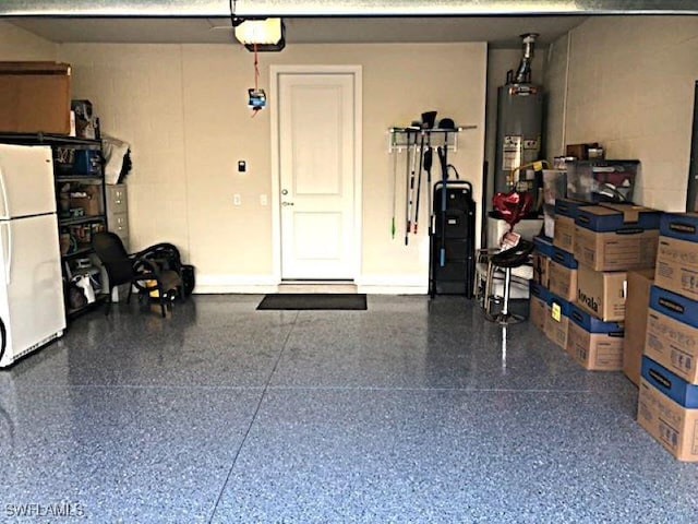 garage featuring a garage door opener, freestanding refrigerator, water heater, and concrete block wall