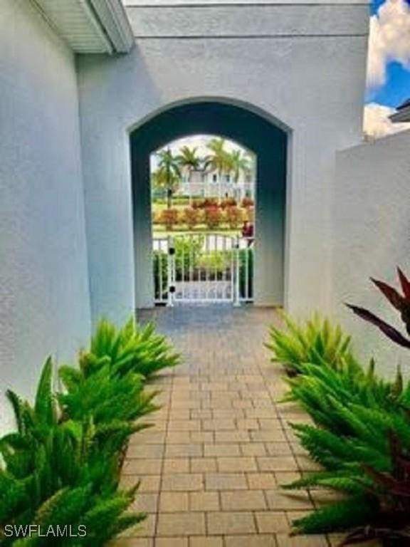 doorway to property featuring stucco siding