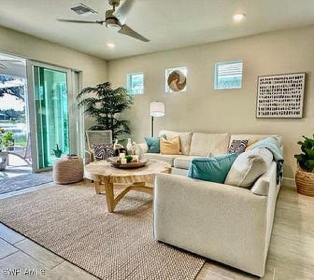 living room with ceiling fan, recessed lighting, baseboards, and a healthy amount of sunlight