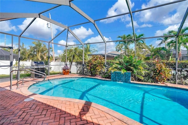 view of swimming pool featuring a patio, a lanai, and pool water feature