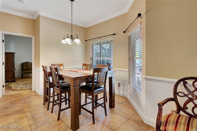 dining room with light tile patterned floors, crown molding, and a chandelier