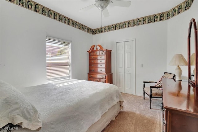 bedroom featuring light carpet, a closet, and ceiling fan