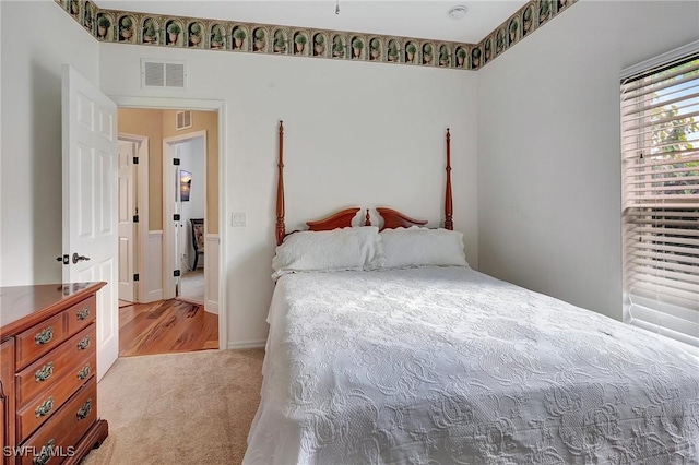 bedroom featuring light colored carpet