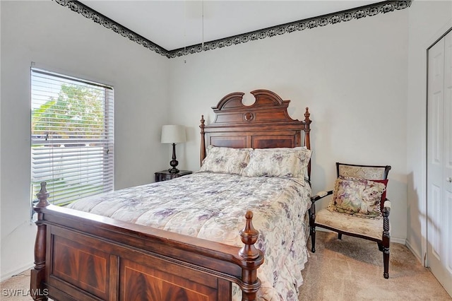 bedroom with light colored carpet and a closet