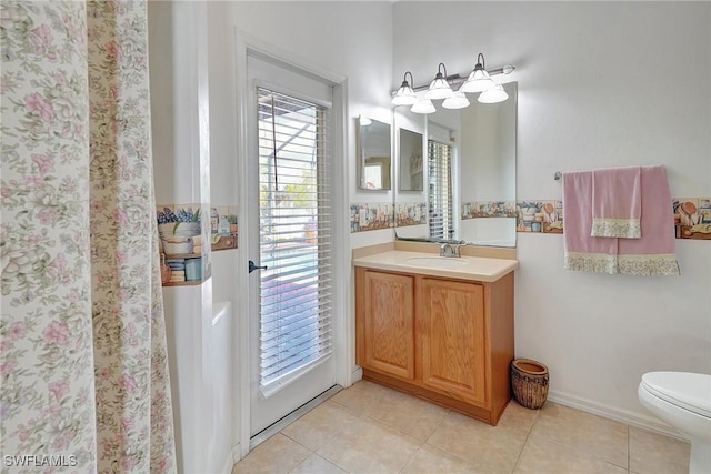 bathroom with vanity, toilet, and tile patterned flooring