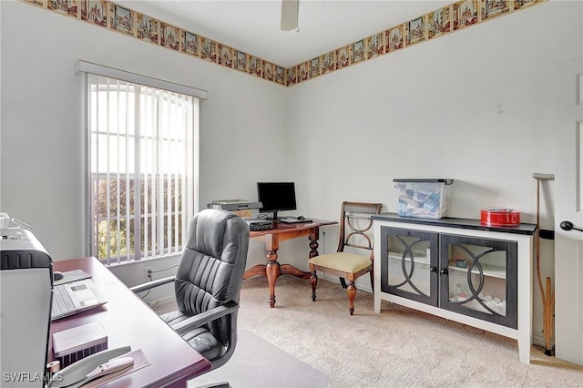 office space featuring light colored carpet and ceiling fan