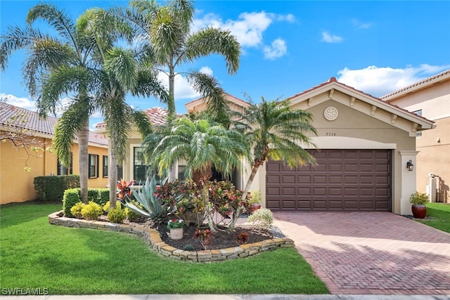 mediterranean / spanish home with a garage and a front yard