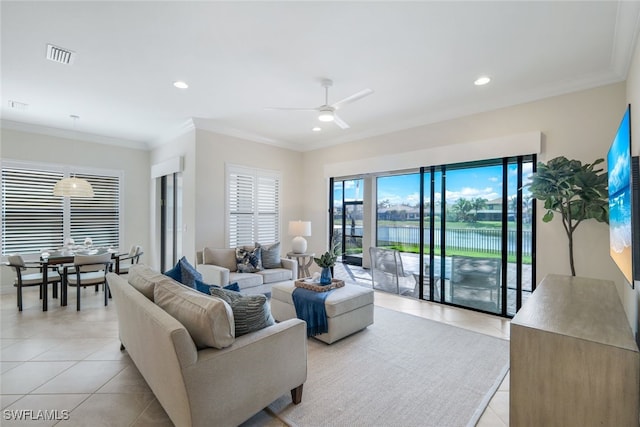 living room with ornamental molding, light tile patterned floors, and ceiling fan