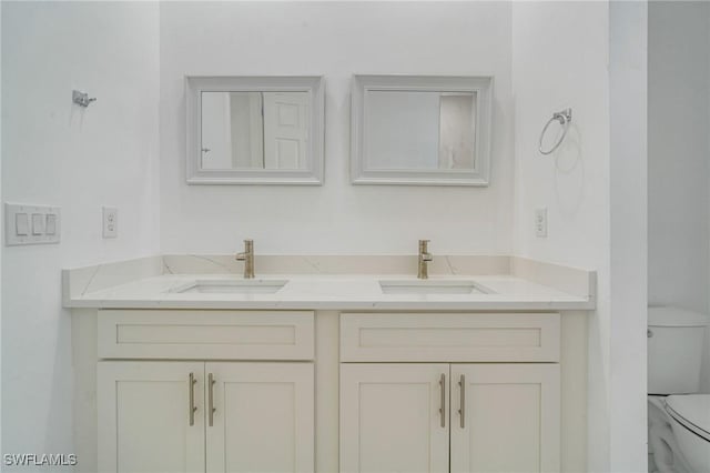 bathroom with vanity and toilet