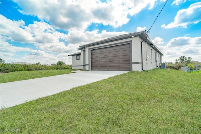 view of front of property featuring a garage, central AC, and a front lawn