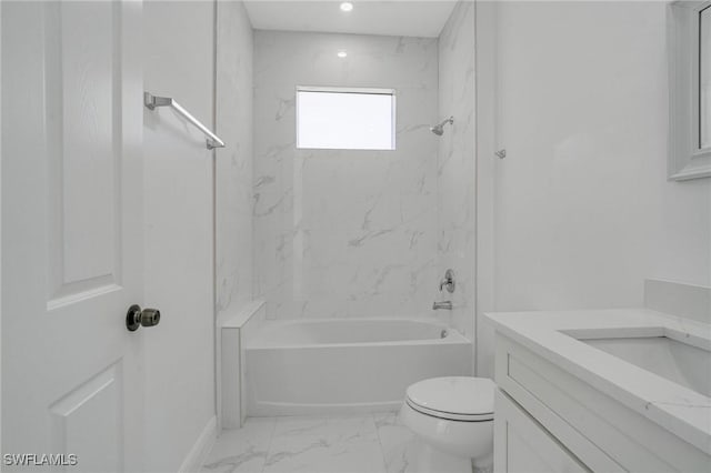 full bathroom with tiled shower / bath, vanity, and toilet