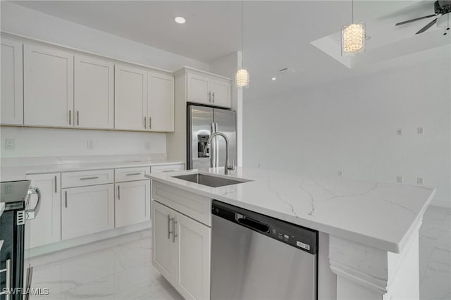 kitchen with stainless steel appliances, white cabinetry, a kitchen island with sink, and pendant lighting