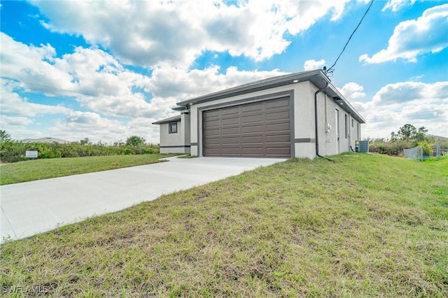 view of front of property featuring a garage, a front lawn, and central air condition unit