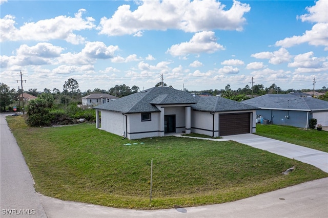 ranch-style home featuring a garage and a front lawn