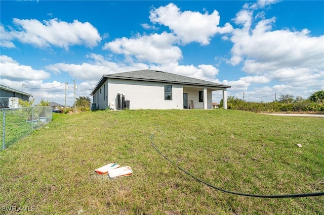 back of property featuring a yard