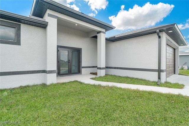 view of side of property featuring a garage and a lawn