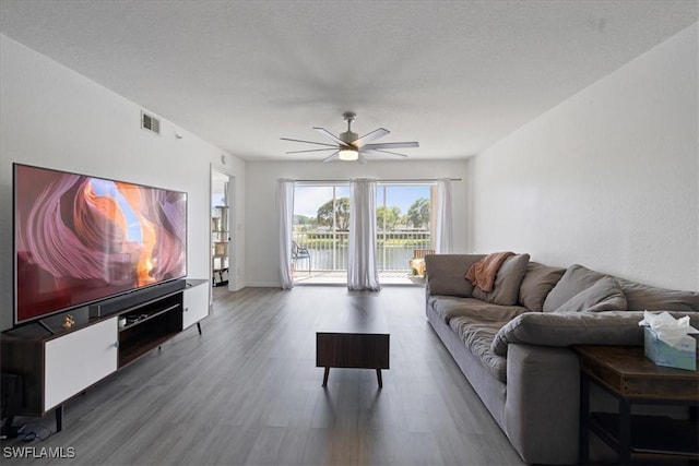 living room with ceiling fan and hardwood / wood-style floors