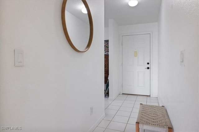 hall featuring light tile patterned floors