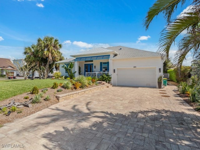 view of front of home with a garage and a front yard