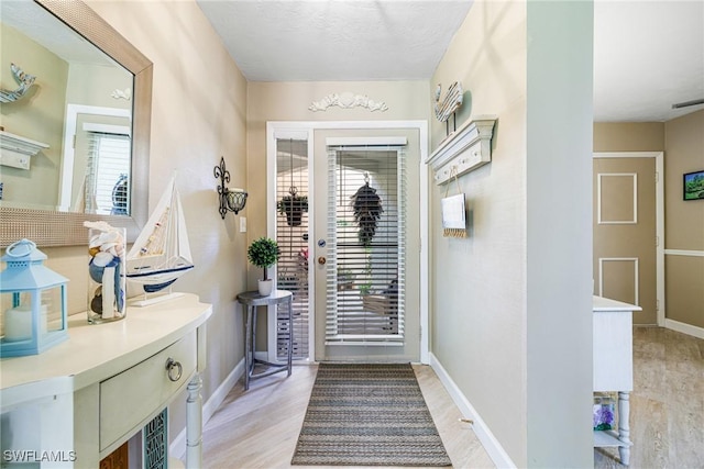 doorway to outside with light hardwood / wood-style floors