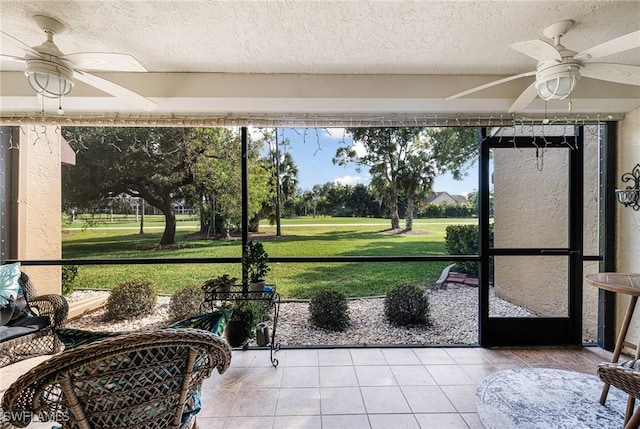 sunroom featuring ceiling fan