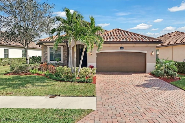 mediterranean / spanish-style home with a garage and a front lawn