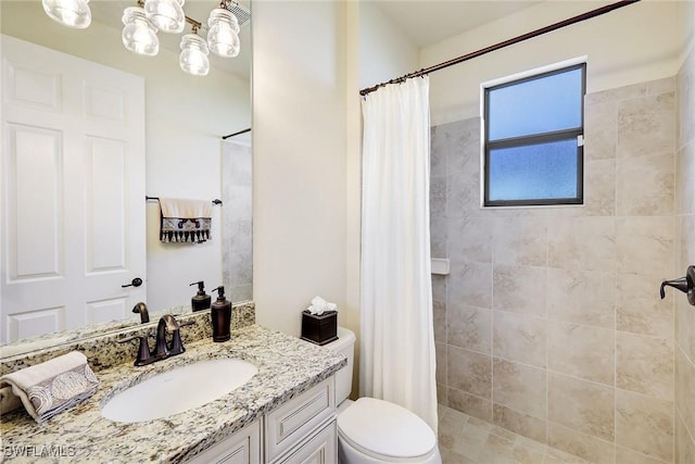 bathroom with vanity, toilet, and curtained shower