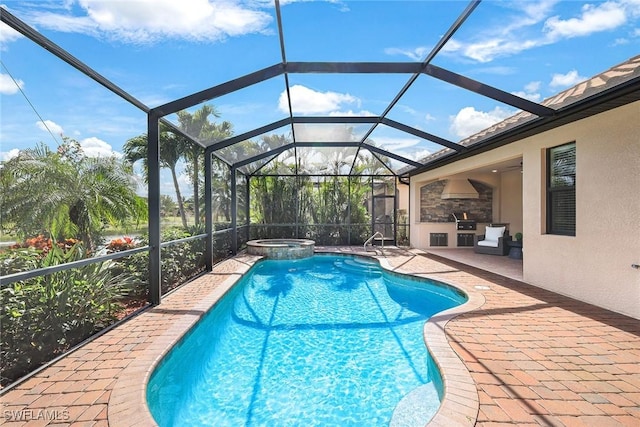 view of swimming pool with an outdoor kitchen, a patio, glass enclosure, and an in ground hot tub