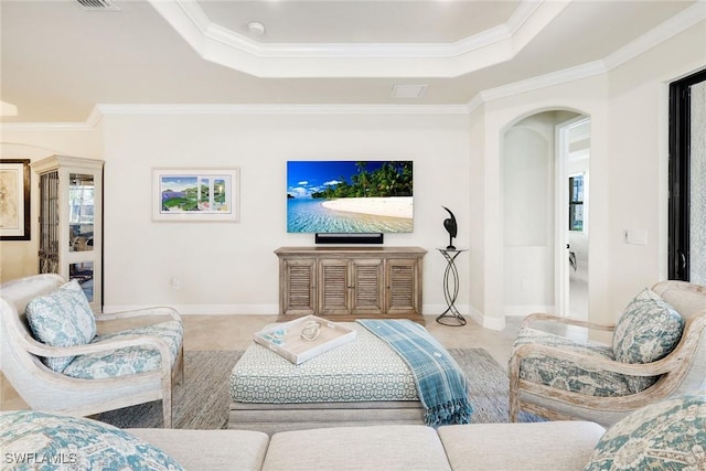 living room with ornamental molding, light tile patterned floors, and a tray ceiling