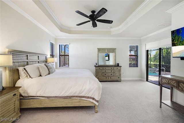 carpeted bedroom with ornamental molding, access to outside, ceiling fan, and a tray ceiling