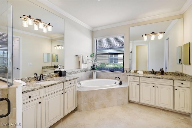 bathroom with tiled tub, crown molding, tile patterned flooring, and vanity