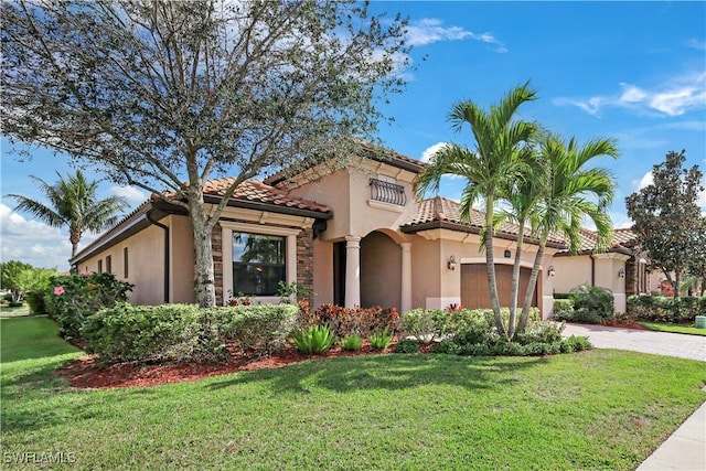 mediterranean / spanish house with a garage and a front yard