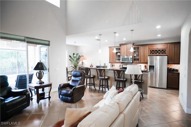 tiled living room featuring a towering ceiling