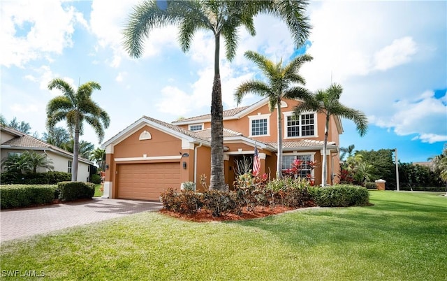 view of front of property featuring a garage and a front lawn