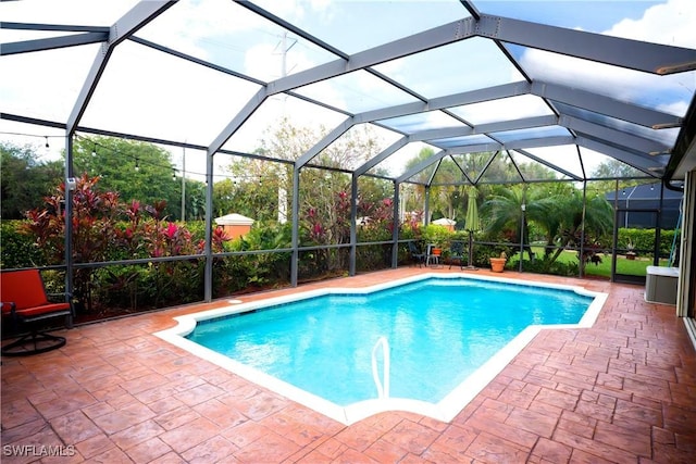 view of pool with a lanai and a patio