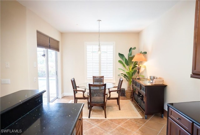 dining space featuring light tile patterned flooring