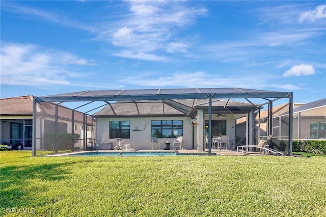 rear view of property with a yard, a patio area, and glass enclosure