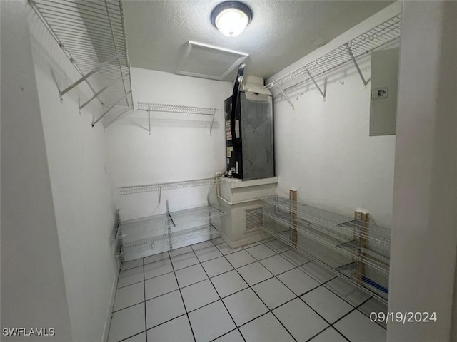 spacious closet featuring heating unit and light tile patterned floors