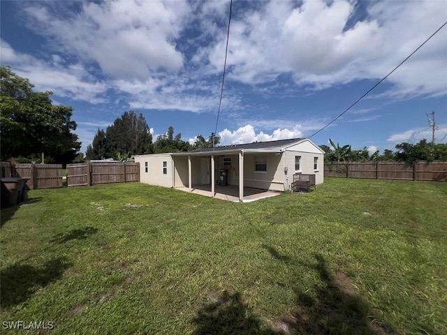 rear view of property featuring a patio and a lawn