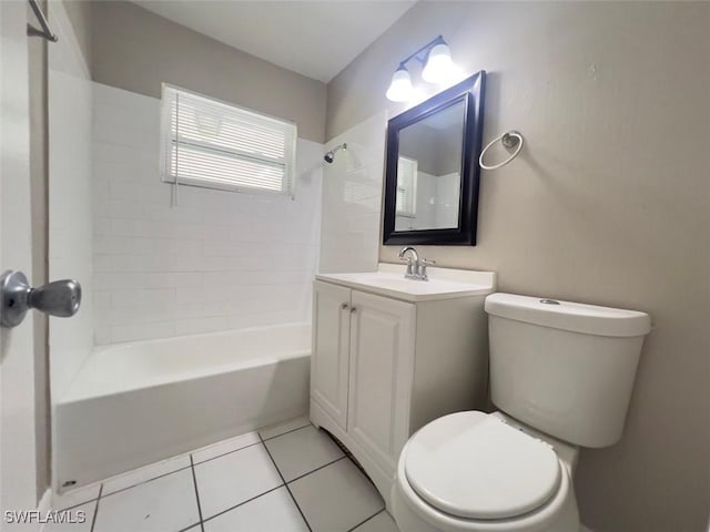 full bathroom featuring tiled shower / bath, tile patterned floors, toilet, and vanity