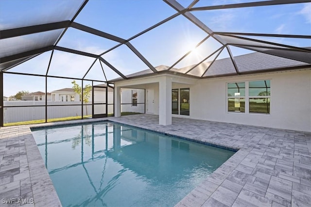 view of pool featuring a patio area and glass enclosure