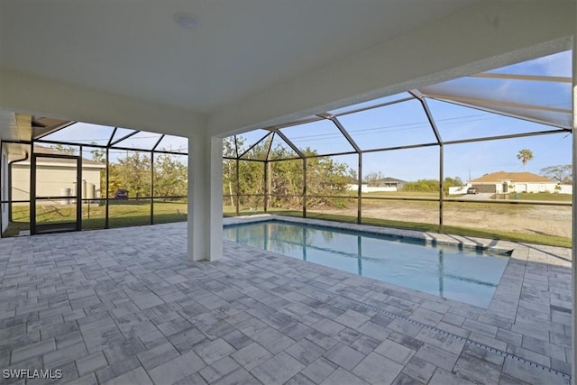 view of swimming pool featuring a lanai and a patio area